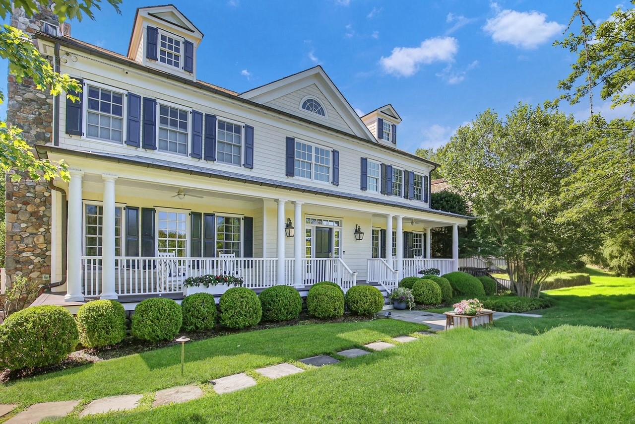 a front view of a house with a yard table and chairs