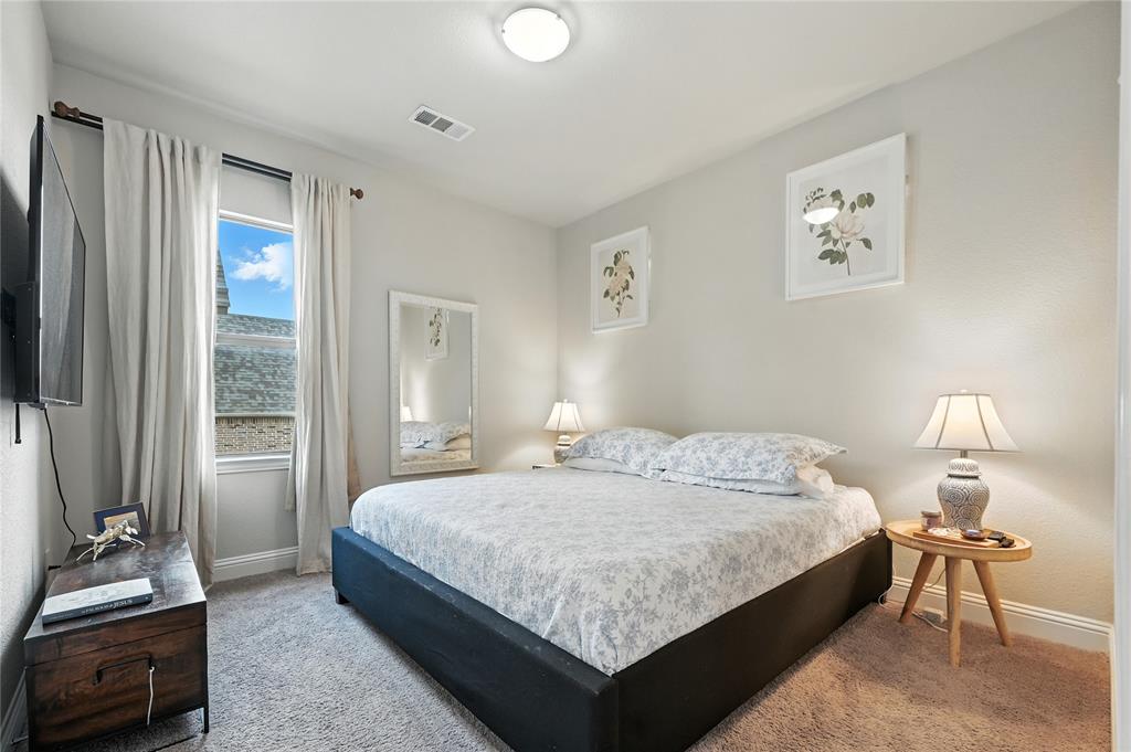 1160 Red Hawk Lane Forney, TX 75126 - Photo 13 of 26 a bedroom with a bed and a lamp with window