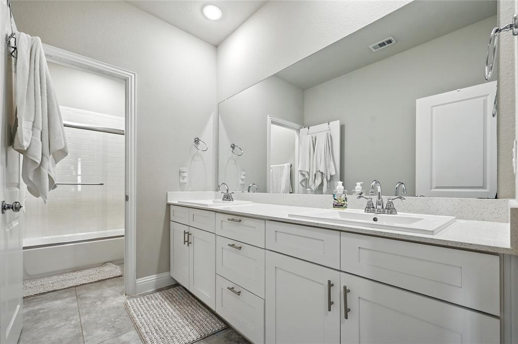 1160 Red Hawk Lane Forney, TX 75126 - Photo 16 of 26 a bathroom with a double vanity sink mirror and double