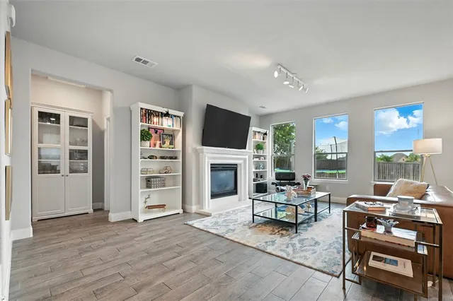 a living room with furniture a fireplace and a flat screen tv