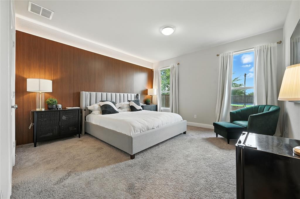 1160 Red Hawk Lane Forney, TX 75126 - Photo 9 of 26 a bedroom with a bed and a couch