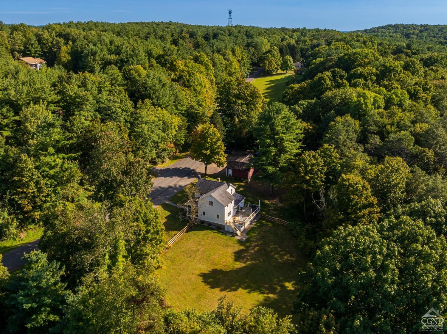 613 Fischer Road Kinderhook, NY 12106 - Photo 2 of 21 a view of a forest with a houses