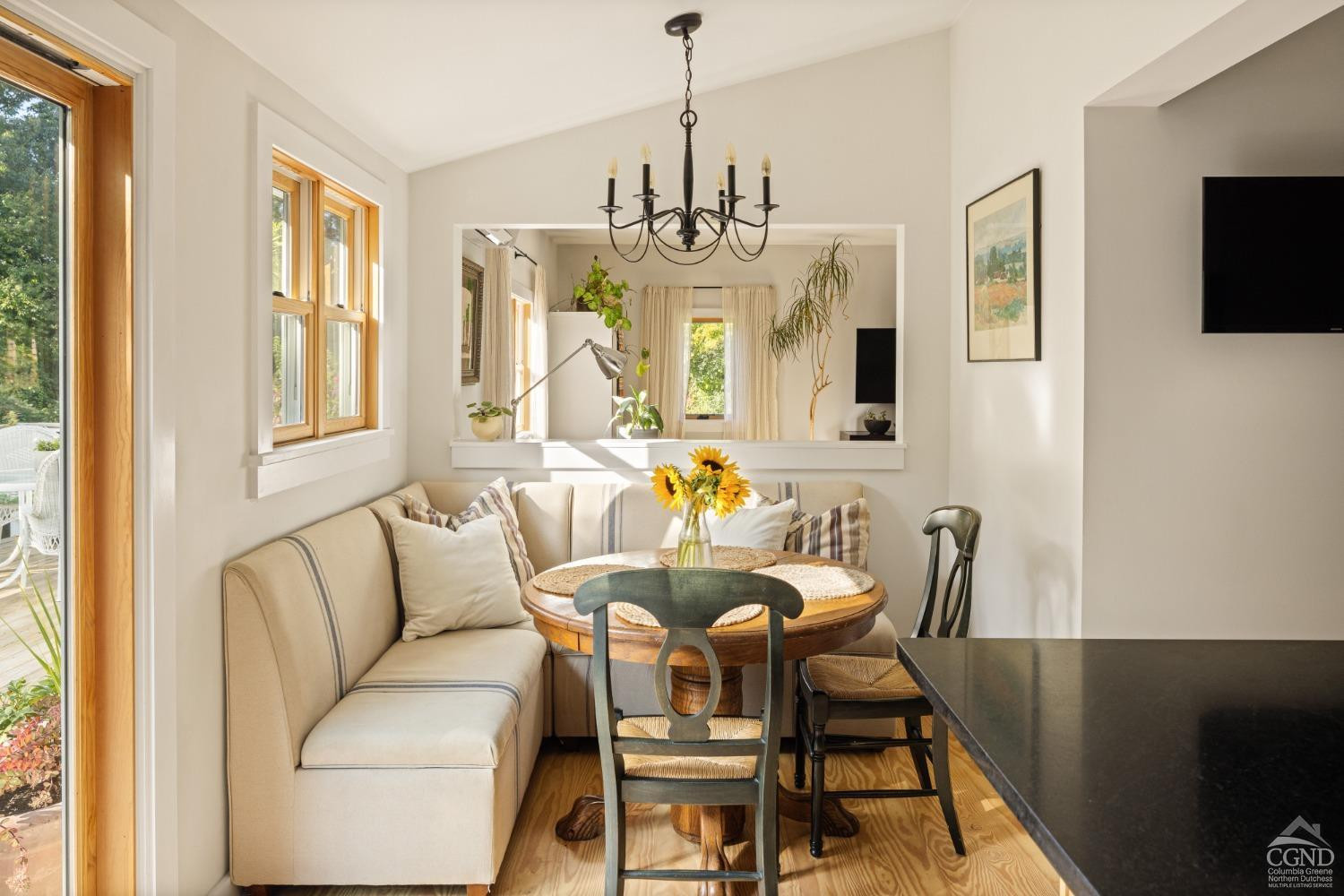 613 Fischer Road Kinderhook, NY 12106 - Photo 7 of 21 a dining room with furniture a chandelier and wooden floor