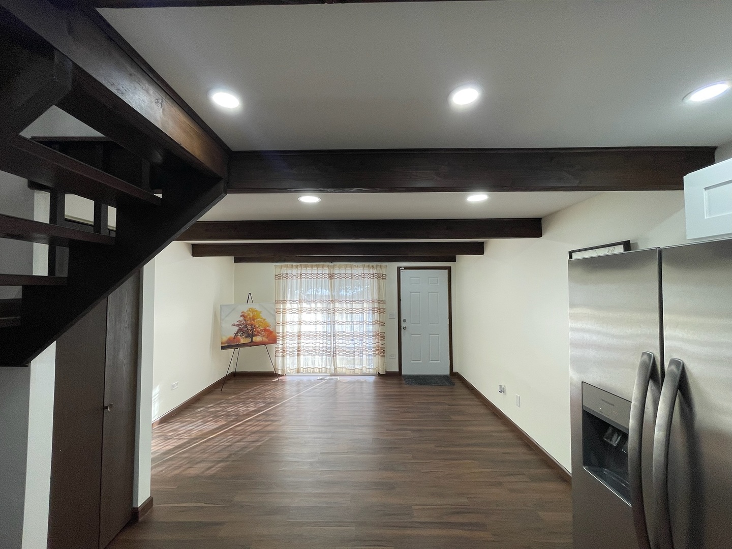 149 Forest Avenue, Unit D Fox Lake, IL 60020 - Photo 21 of 44 a view of an empty room with wooden floor and a kitchen