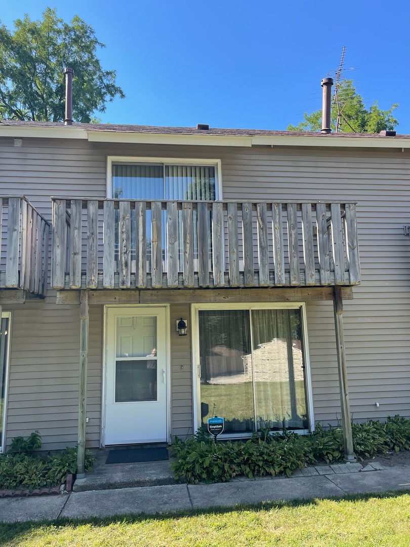 149 Forest Avenue, Unit D Fox Lake, IL 60020 - Photo 34 of 44 a front view of a house with a yard and potted plants
