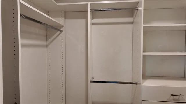 a view of a room with wooden floor and white walls