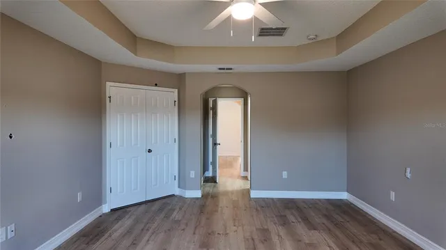 a bathroom with a granite countertop sink a mirror and a shower