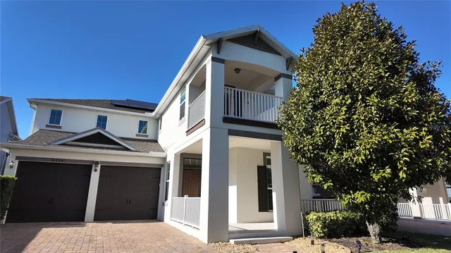 a view of a house with a large window and potted plants