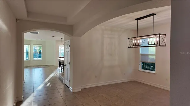 a kitchen with stainless steel appliances kitchen island granite countertop a refrigerator and a stove top oven