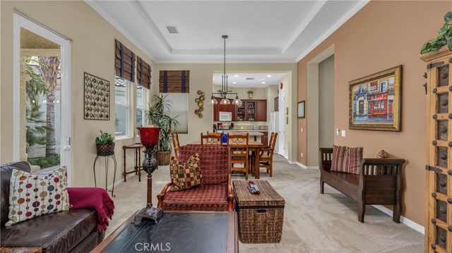 a dining room with furniture a rug and a chandelier