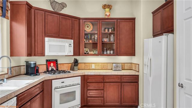 a kitchen with stainless steel appliances a cabinets and a window