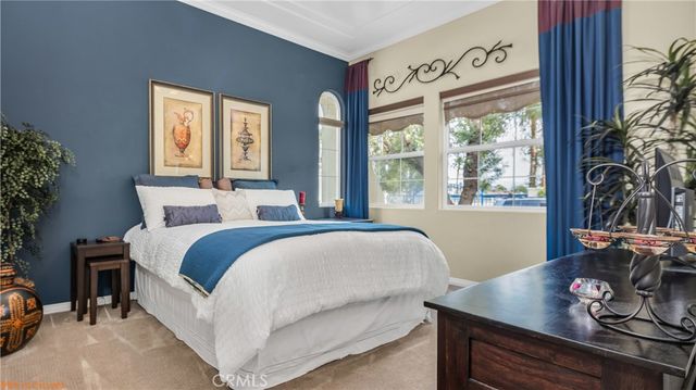 a bedroom with a large bed and a window