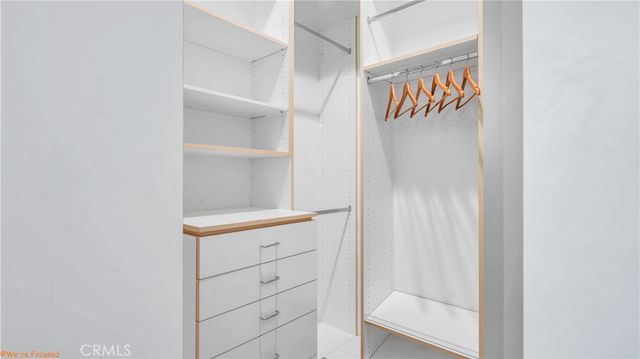 a bedroom with two beds and a window