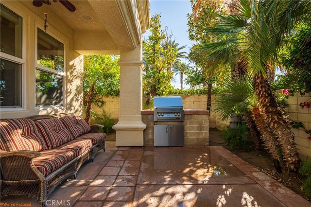 a view of a patio with chair and tables