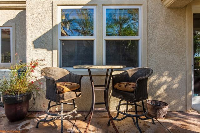 a view of a backyard with a table and chairs in patio