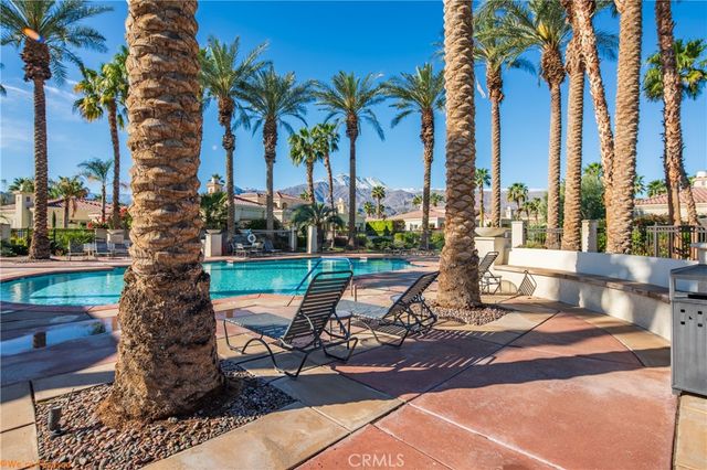 a view of swimming pool with outdoor seating
