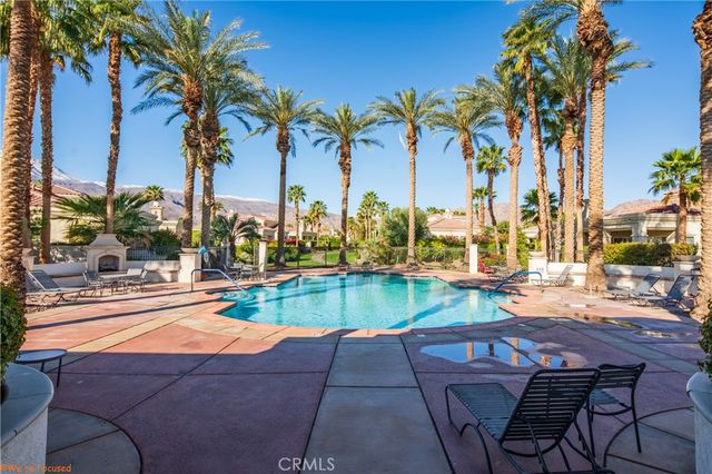 a view of a swimming pool with outdoor seating