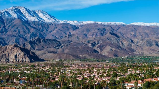 an aerial view of residential house and sandy dunes