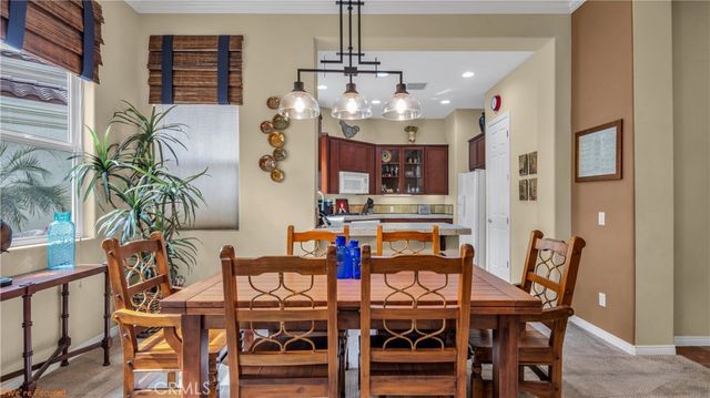 a view of a dining room with furniture and chandelier