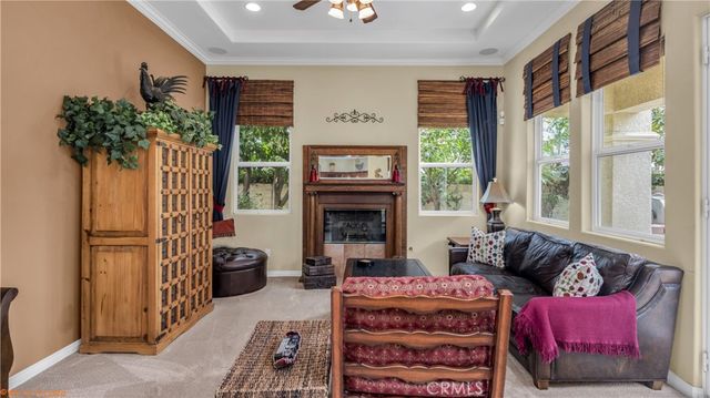 a living room with furniture a large window and a fireplace