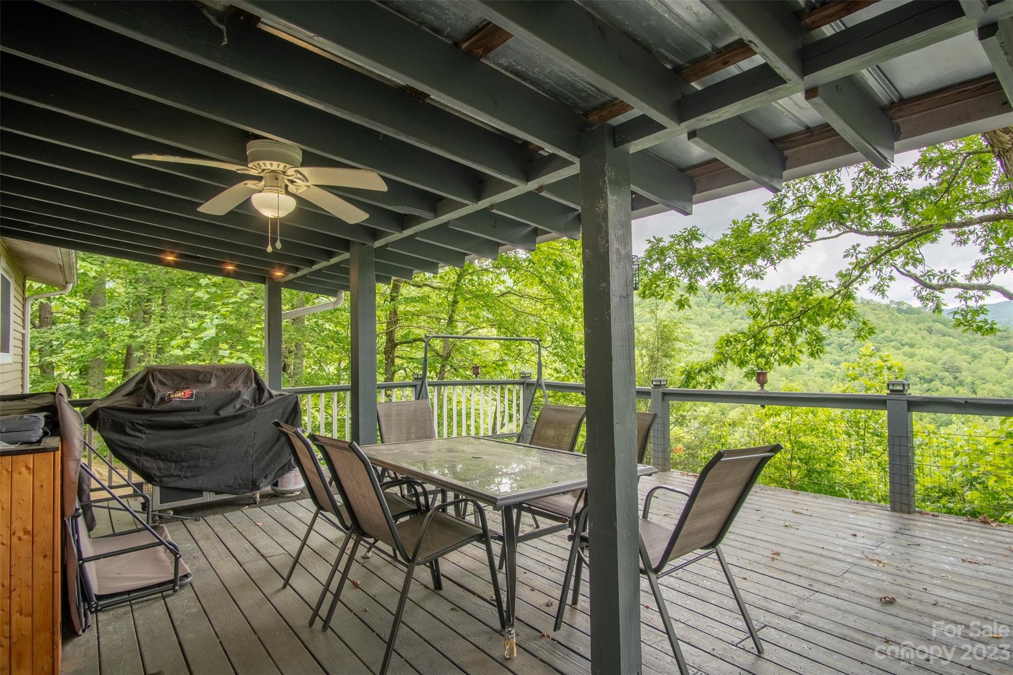 21 Turtle Rock Lane Tuckasegee, NC 28783 - Photo 3 of 32 a view of a chairs and table in patio with wooden floor