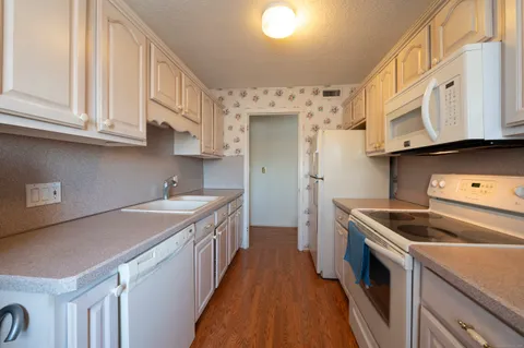 a kitchen with stainless steel appliances granite countertop a sink and a stove