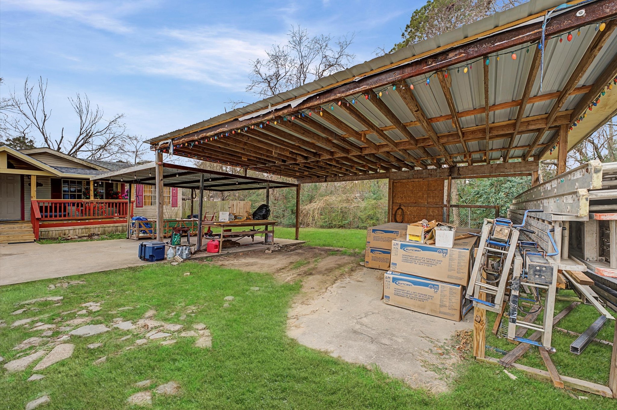 19417 Haude Road Spring, TX 77388 - Photo 27 of 29 a view of a backyard with table and chairs under an umbrella with a barbeque