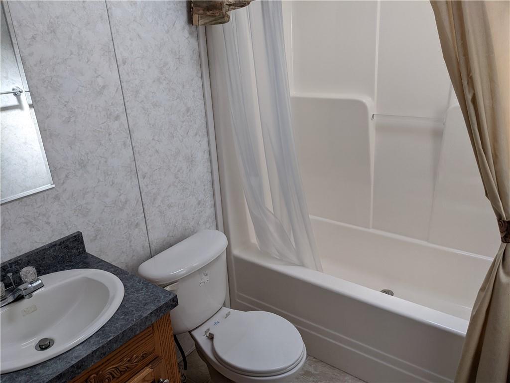 401 Keck Road Butler, PA 16002 - Photo 13 of 13 a white toilet sitting next to a bathroom sink and tub