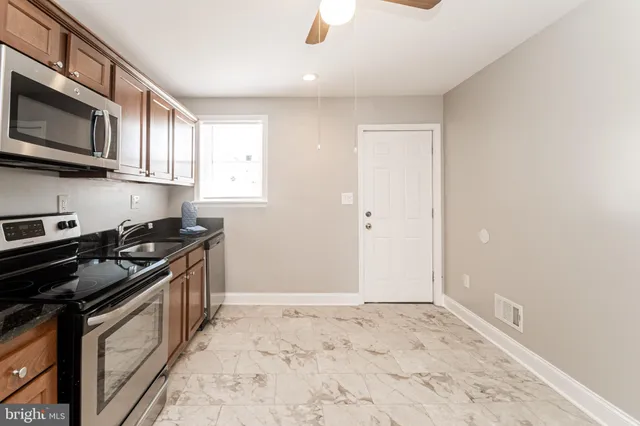 a kitchen with stainless steel appliances granite countertop a stove and a sink