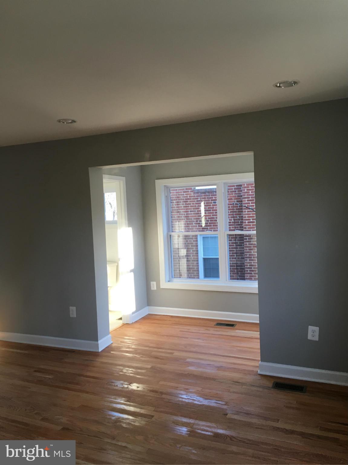 620 Woodside Parkway Silver Spring, MD 20910 - Photo 3 of 11 a view of an empty room with wooden floor and a window