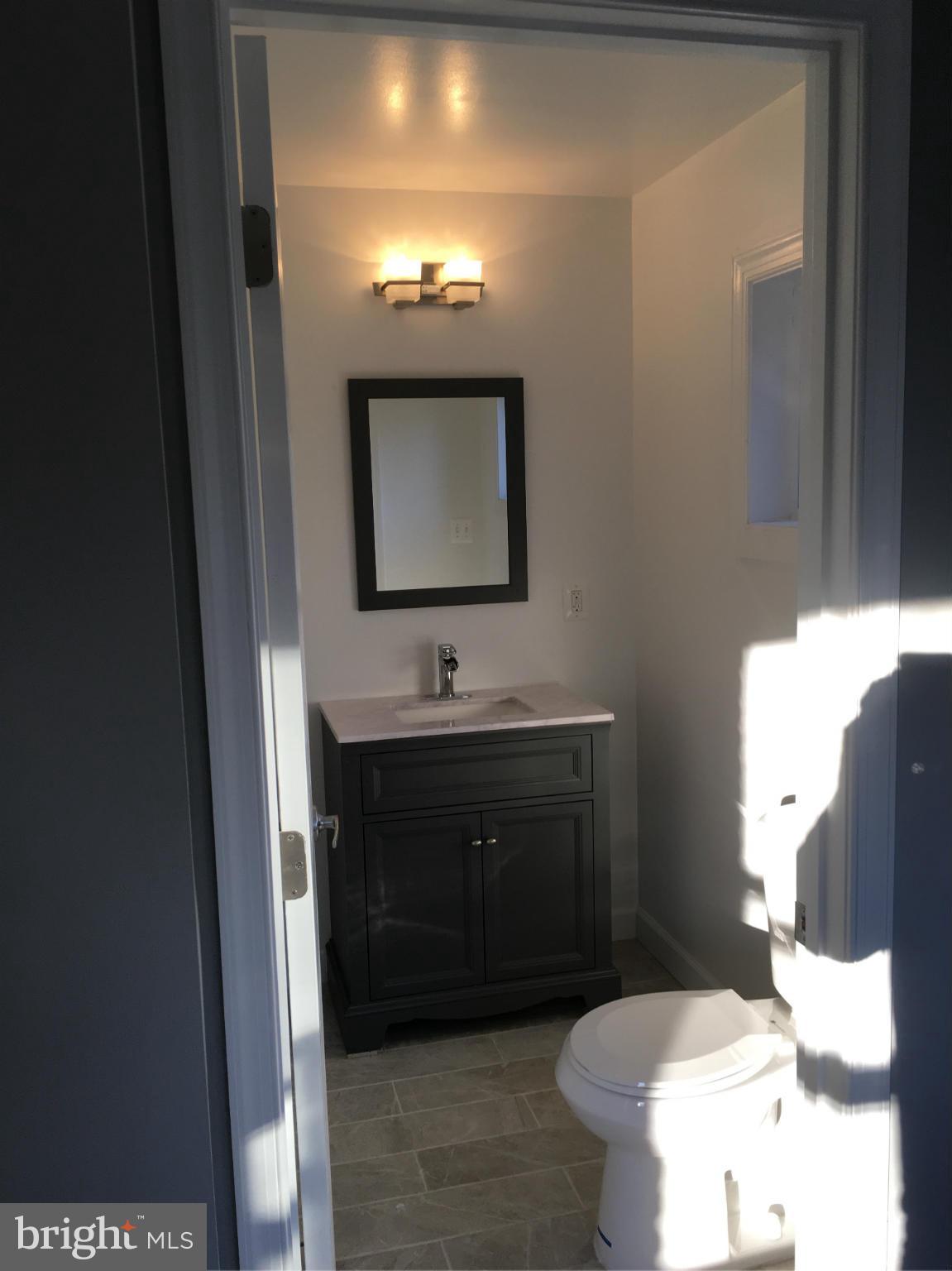 620 Woodside Parkway Silver Spring, MD 20910 - Photo 4 of 11 a bathroom with a sink and a mirror