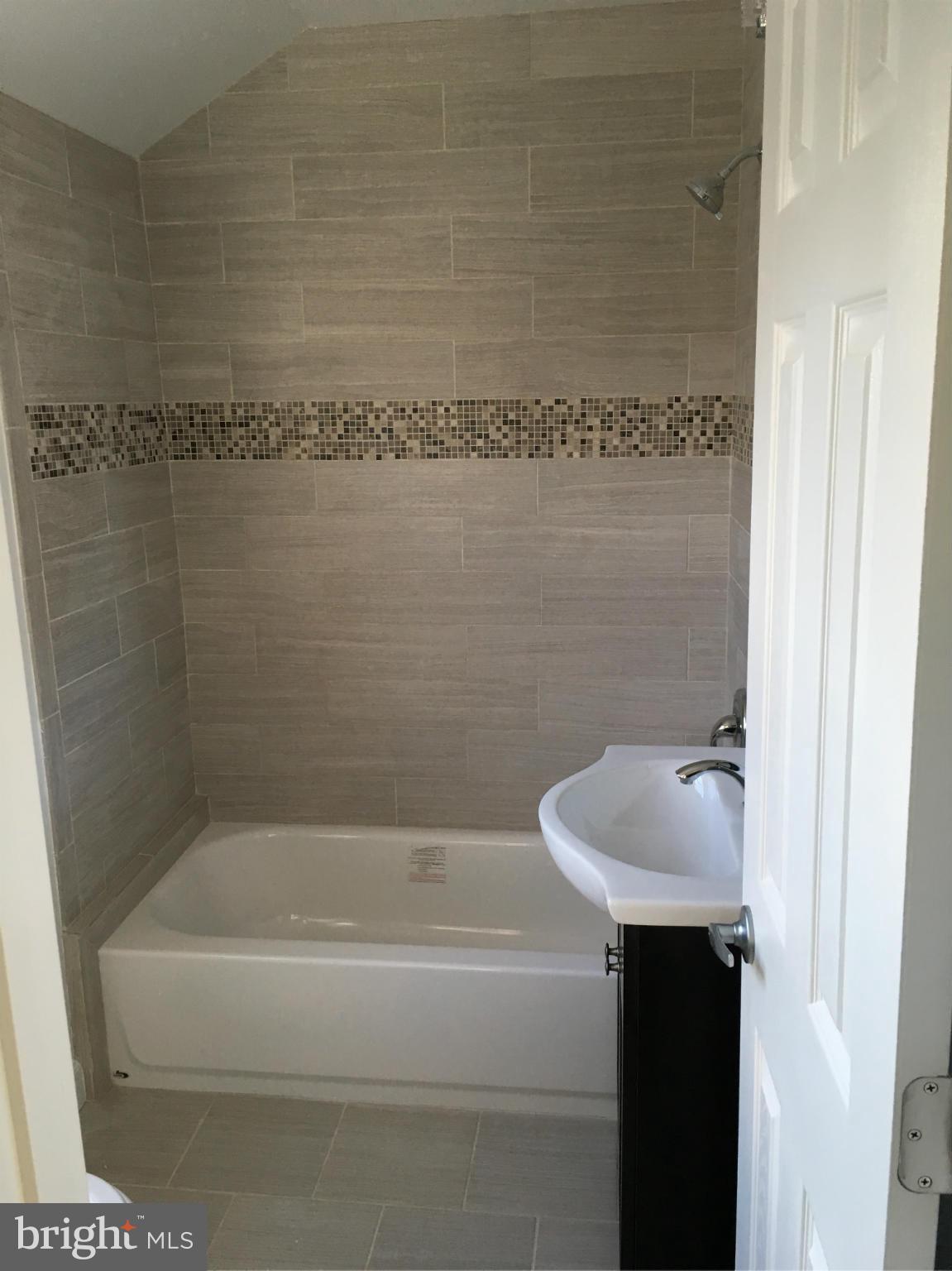 620 Woodside Parkway Silver Spring, MD 20910 - Photo 6 of 11 a bathroom with a shower and a bathtub