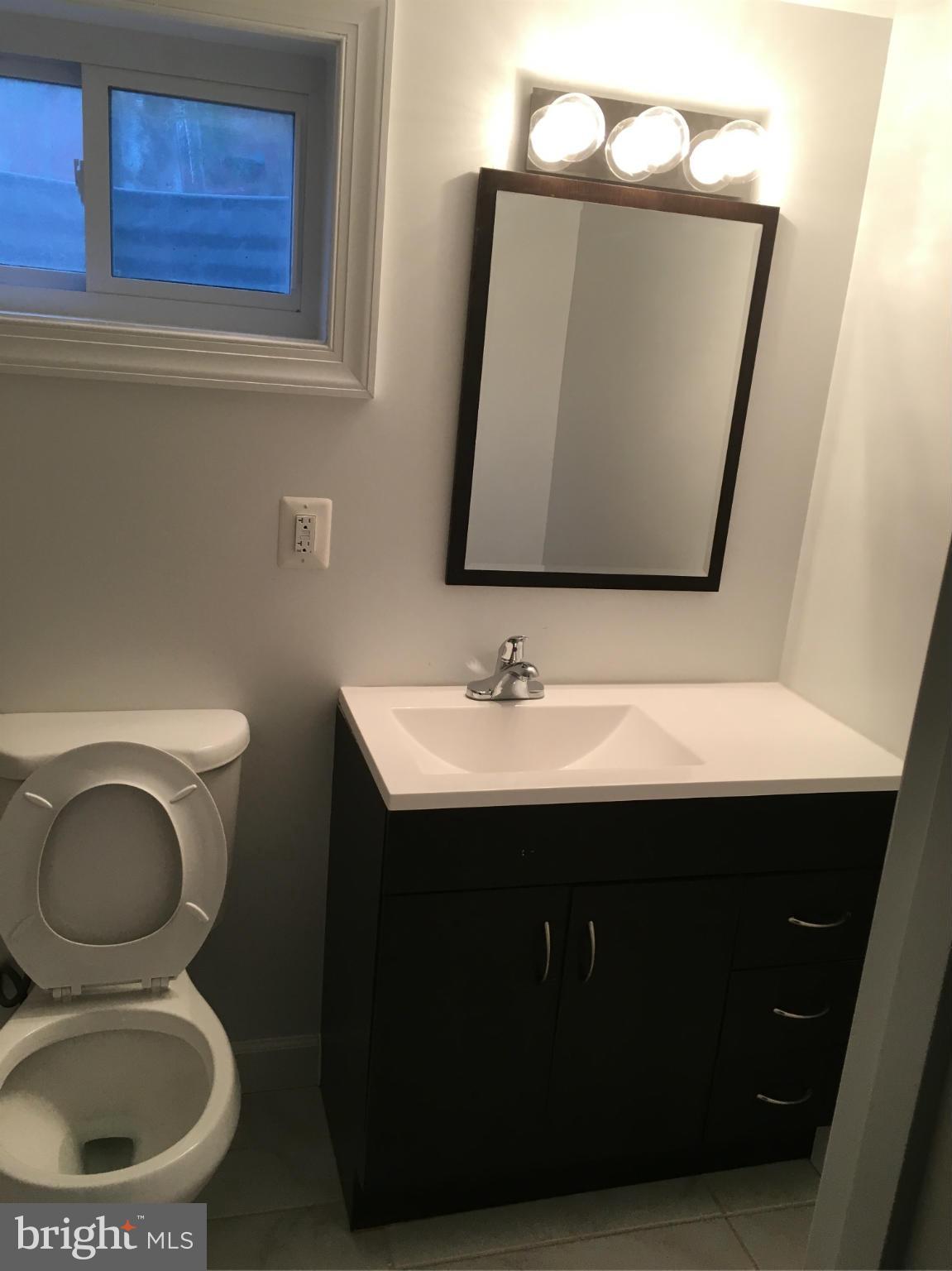 620 Woodside Parkway Silver Spring, MD 20910 - Photo 10 of 11 a bathroom with a toilet sink and mirror