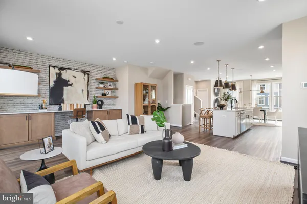 a living room with furniture and view of kitchen
