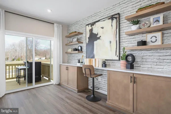 a kitchen with stainless steel appliances granite countertop a refrigerator a sink and white cabinets