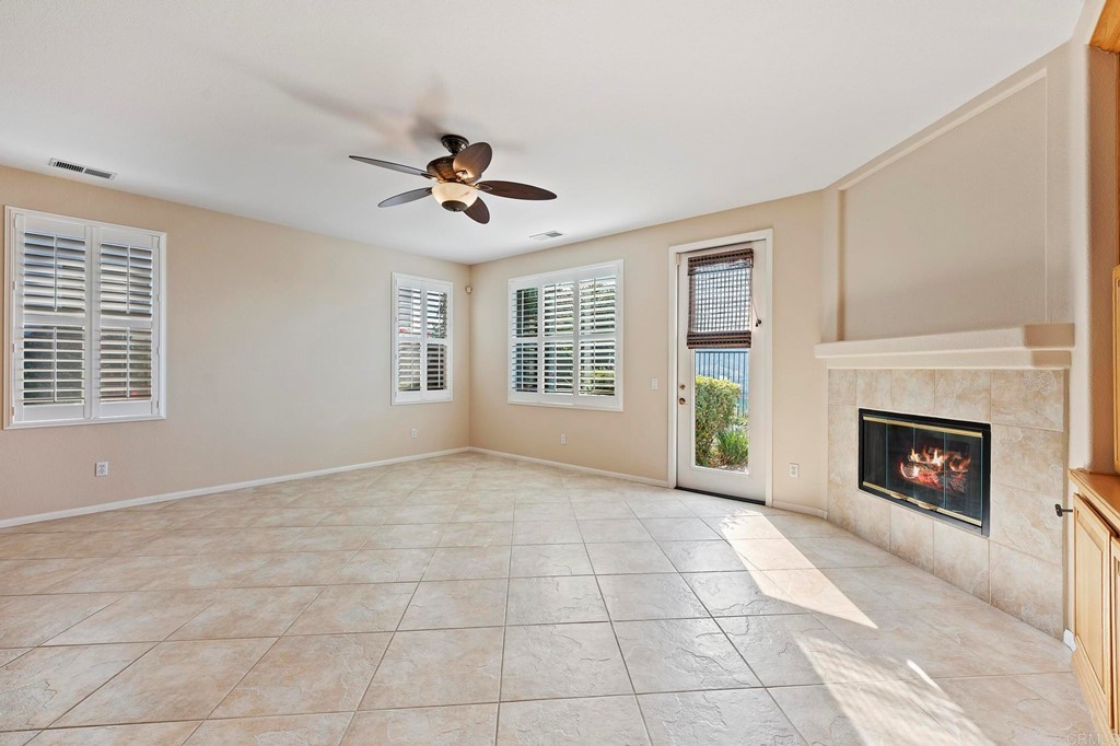 1533 Brookside Court San Marcos, CA 92078 - Photo 12 of 46 a view of an empty room with a fireplace and a window