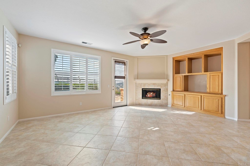 1533 Brookside Court San Marcos, CA 92078 - Photo 13 of 46 a view of an empty room with a fireplace and a window