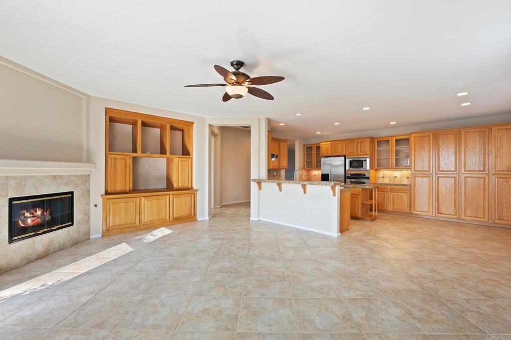 1533 Brookside Court San Marcos, CA 92078 - Photo 14 of 46 a view of a livingroom with furniture a fireplace and window