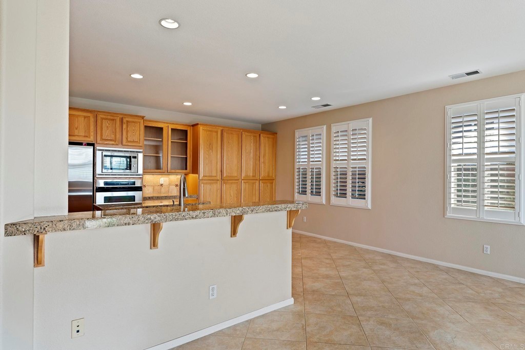 1533 Brookside Court San Marcos, CA 92078 - Photo 16 of 46 a view of kitchen with stainless steel appliances granite countertop refrigerator sink and stove