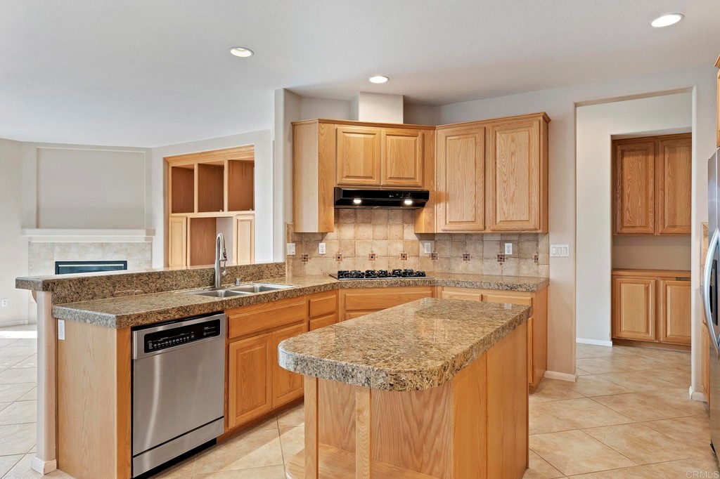 1533 Brookside Court San Marcos, CA 92078 - Photo 18 of 46 a kitchen with stainless steel appliances granite countertop a stove a sink and a refrigerator