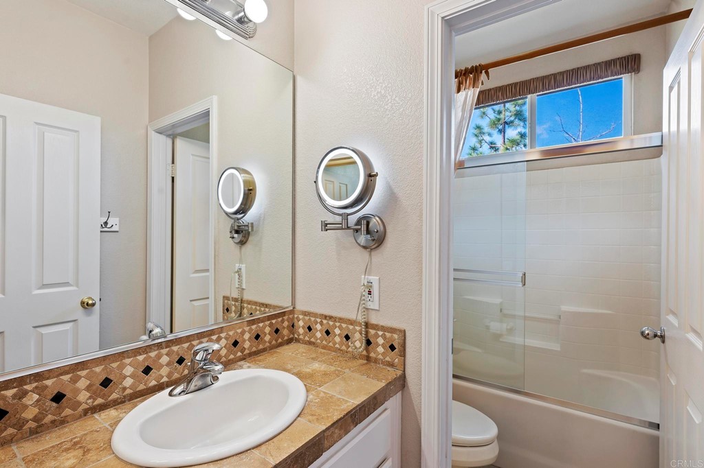 1533 Brookside Court San Marcos, CA 92078 - Photo 25 of 46 a bathroom with a granite countertop sink toilet and shower