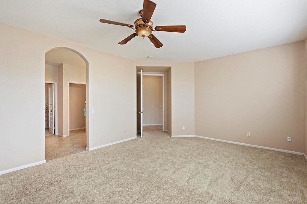 1533 Brookside Court San Marcos, CA 92078 - Photo 33 of 46 an empty room with a ceiling fan and a window
