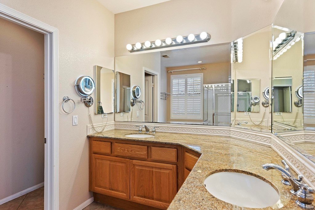 1533 Brookside Court San Marcos, CA 92078 - Photo 35 of 46 a bathroom with a granite countertop sink and a mirror