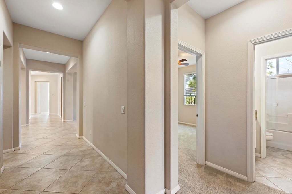 1533 Brookside Court San Marcos, CA 92078 - Photo 4 of 46 a view of a hallway with wooden floor and closet