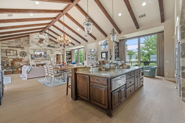 a kitchen with stainless steel appliances granite countertop a stove and cabinets