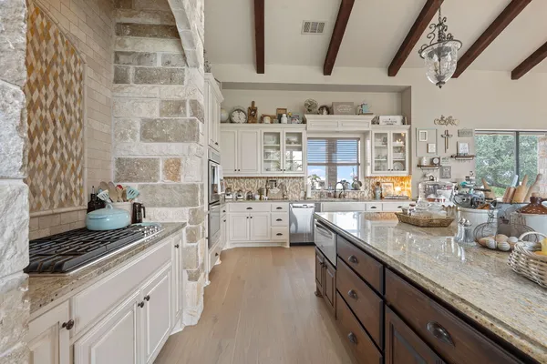 a dining hall with stainless steel appliances kitchen island granite countertop furniture and a view of kitchen