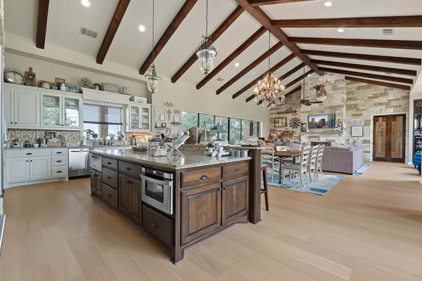 a dining room with furniture a chandelier and fireplace
