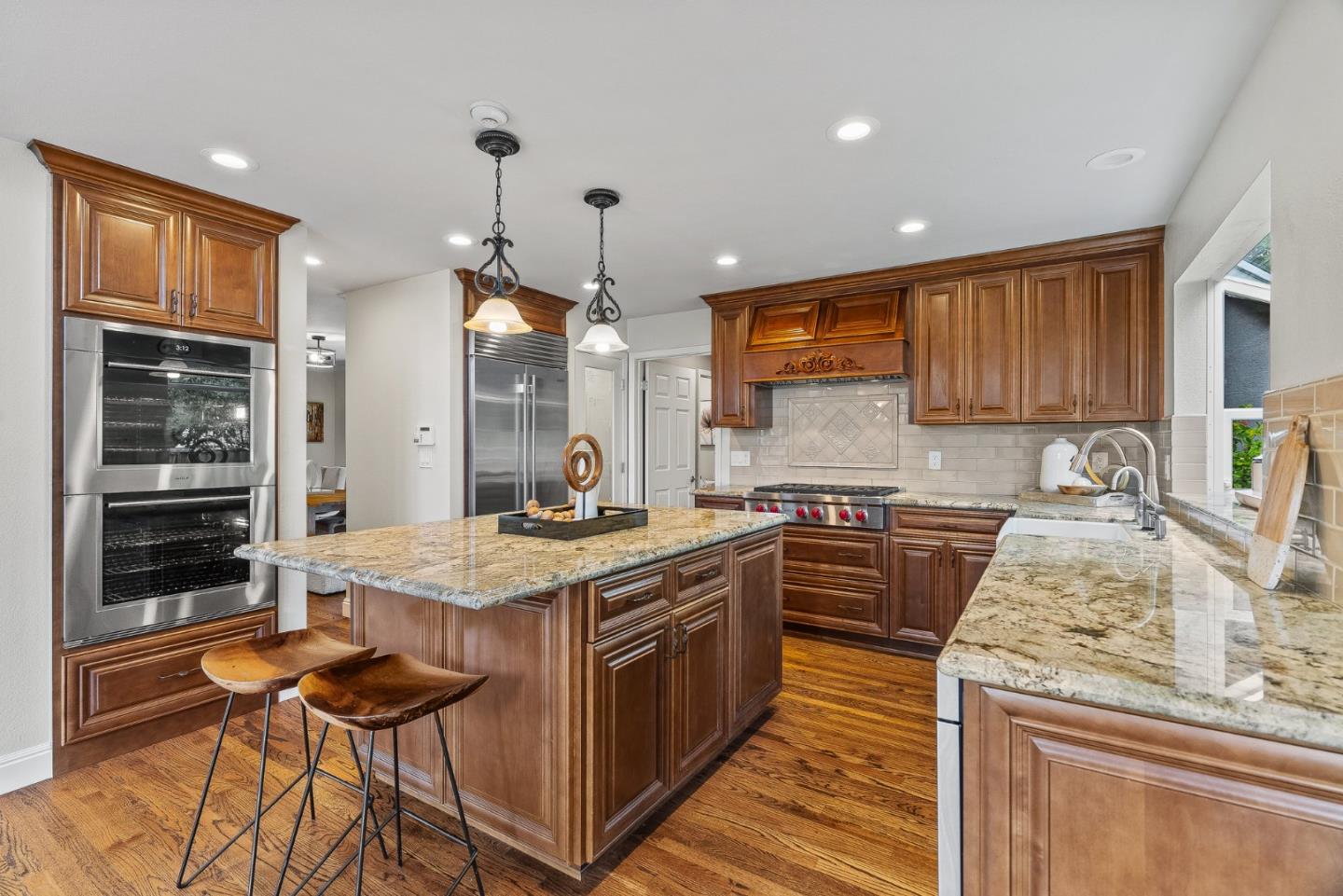 15650 Michael Lane Monte Sereno, CA 95030 - Photo 17 of 54 a kitchen with stainless steel appliances granite countertop wooden cabinets and a stove top oven