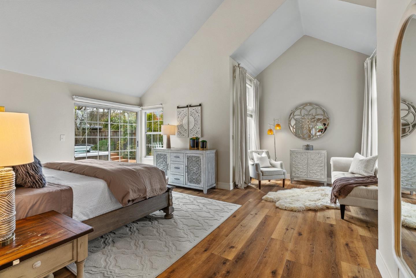 15650 Michael Lane Monte Sereno, CA 95030 - Photo 28 of 54 a spacious bedroom with a bed a table and large windows