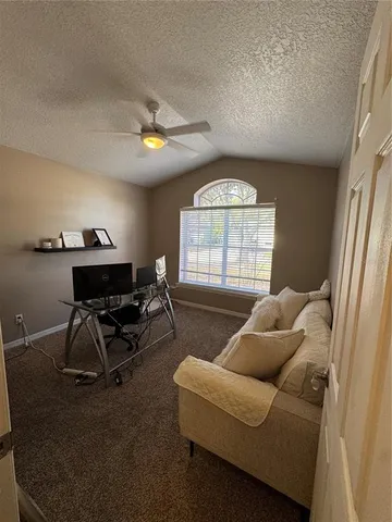 a living room with furniture a chandelier and a window